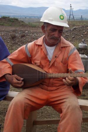 Tofig playing saz during a break in work on the SCP Pipeline, Azerbaijan 2005